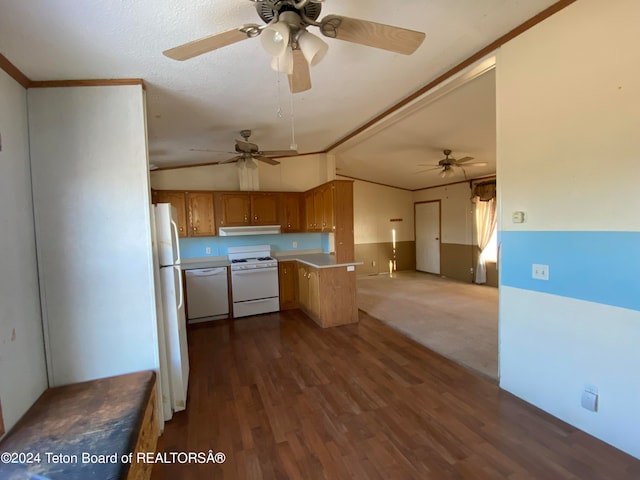 kitchen featuring dark hardwood / wood-style flooring, kitchen peninsula, vaulted ceiling, white appliances, and ornamental molding