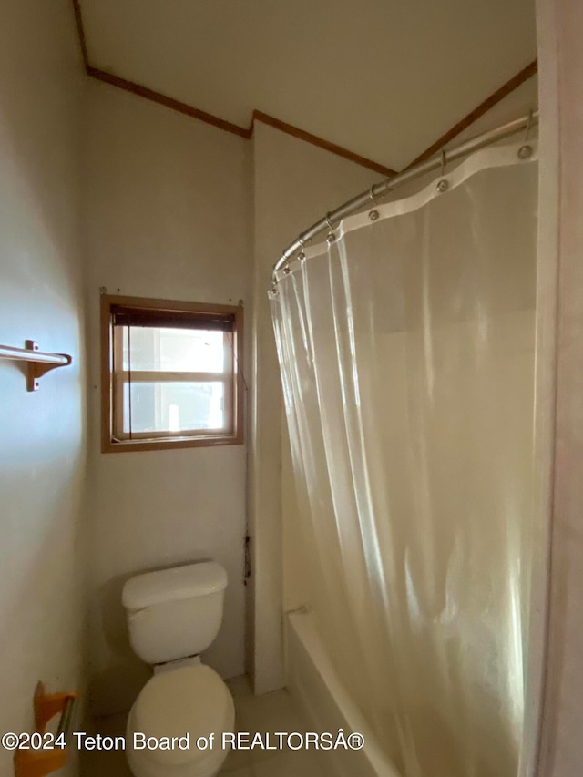 bathroom with shower / bath combo and toilet