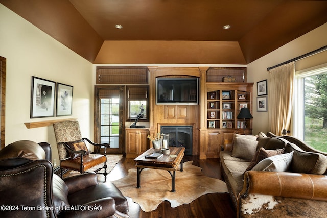 living room with vaulted ceiling and hardwood / wood-style flooring