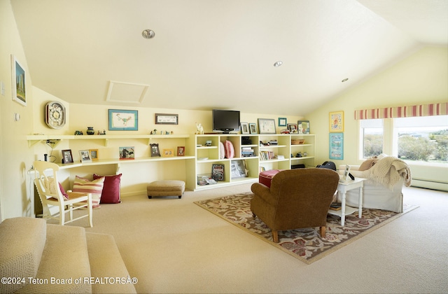 carpeted living room with a baseboard heating unit and vaulted ceiling