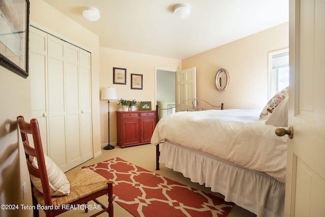 bedroom with light carpet and a closet