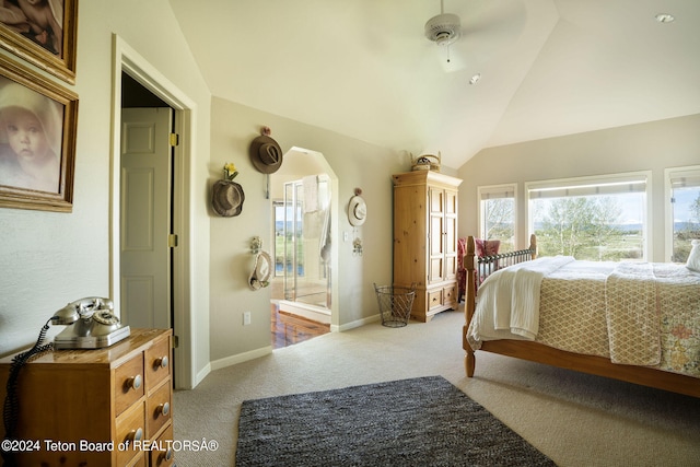 carpeted bedroom with ceiling fan and vaulted ceiling