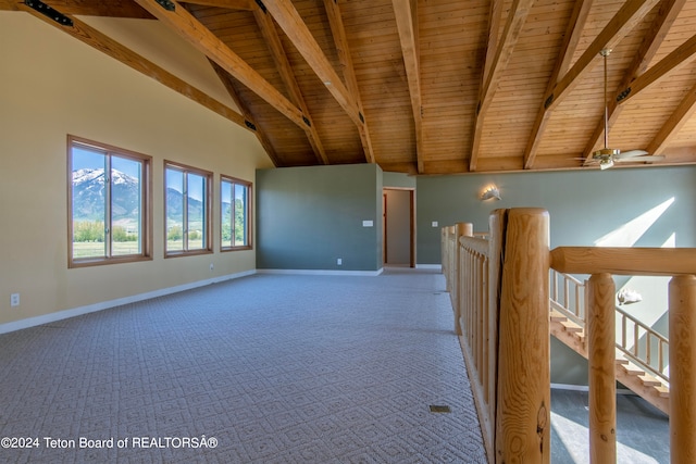 spare room with vaulted ceiling with beams, carpet floors, and wood ceiling