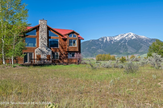 back of house with a deck with mountain view