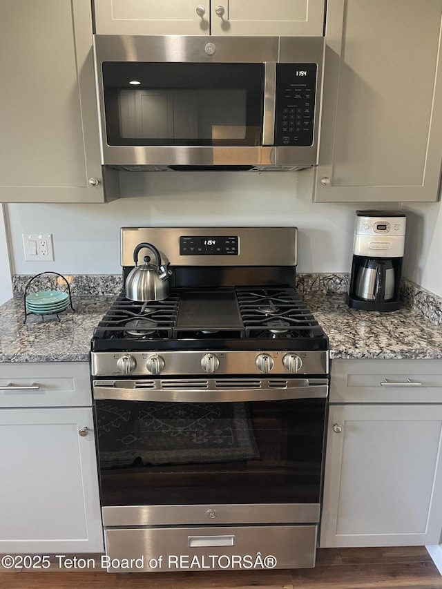 4193 Old Irwin Rd, Irwin, ID 83428 - kitchen featuring light stone countertops, wood finished floors, and appliances with stainless steel finishes