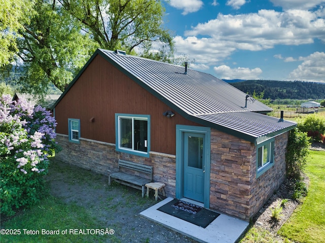 4193 Old Irwin Rd, Irwin, ID 83428 - rear view of house with a standing seam roof, stone siding, and a metal roof