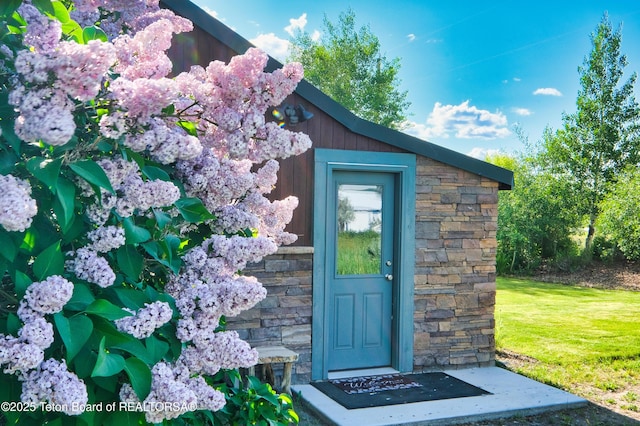 4193 Old Irwin Rd, Irwin, ID 83428 - property entrance with stone siding and a lawn