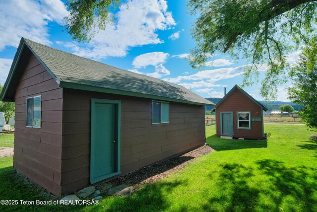 4193 Old Irwin Rd, Irwin, ID 83428 - view of side of home featuring a lawn, an outdoor structure, and roof with shingles