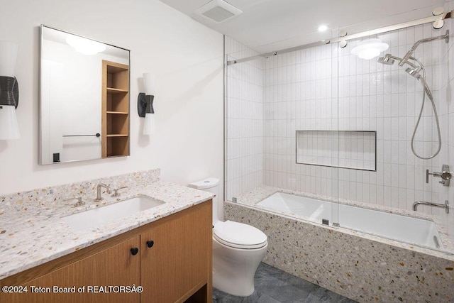 bathroom with tiled shower / bath, visible vents, vanity, and toilet