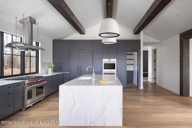 kitchen featuring high end appliances, gray cabinets, a sink, light wood-type flooring, and beamed ceiling