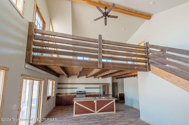 staircase featuring high vaulted ceiling, wood-type flooring, ceiling fan, sink, and beamed ceiling