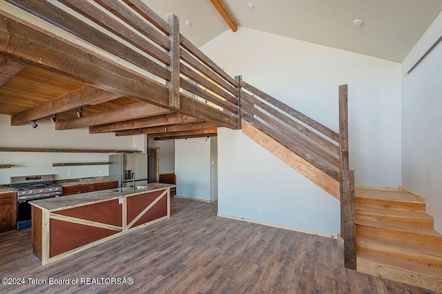 stairway featuring beam ceiling, hardwood / wood-style floors, and sink