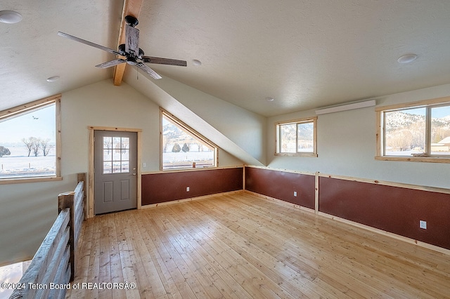 additional living space featuring ceiling fan, light hardwood / wood-style flooring, and a healthy amount of sunlight