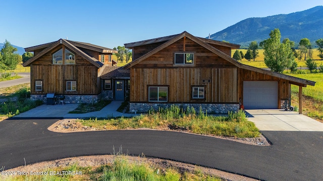 view of front of home with a garage and a mountain view