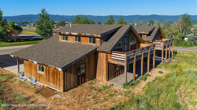 rear view of property featuring a mountain view