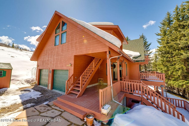 exterior space featuring a wooden deck and a garage