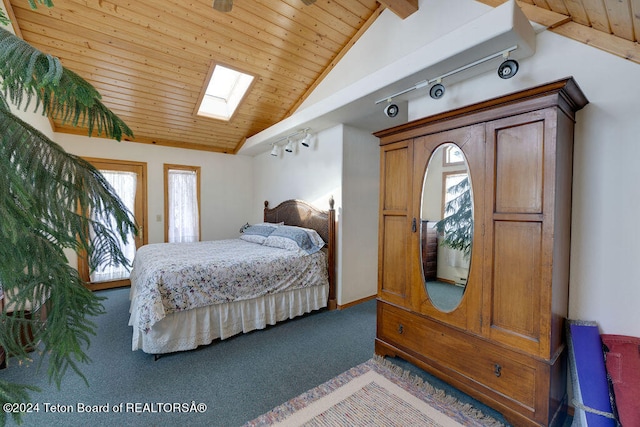 bedroom featuring wood ceiling, carpet floors, rail lighting, and lofted ceiling with skylight