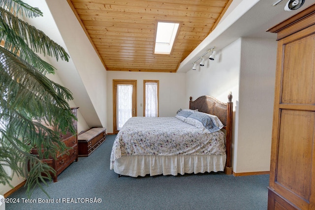 bedroom with wood ceiling, carpet flooring, lofted ceiling with skylight, and track lighting