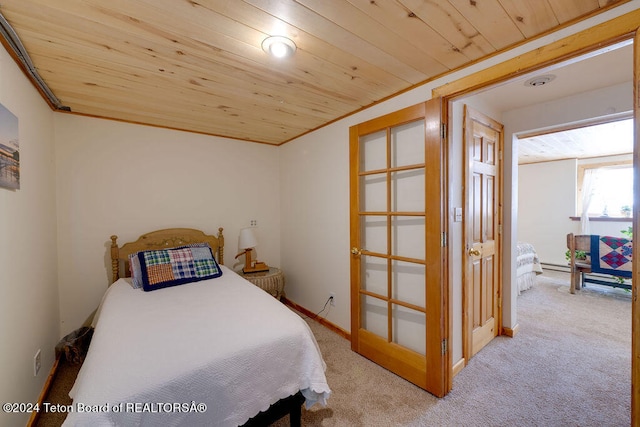 bedroom with wood ceiling and light colored carpet