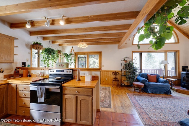 kitchen featuring beamed ceiling, hardwood / wood-style flooring, and stainless steel electric stove