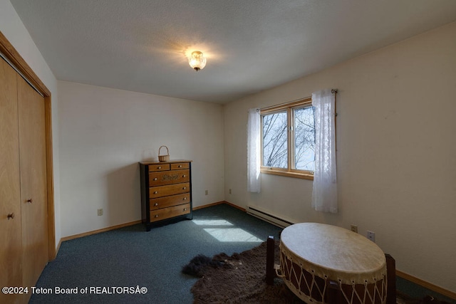 sitting room featuring a baseboard radiator and dark colored carpet