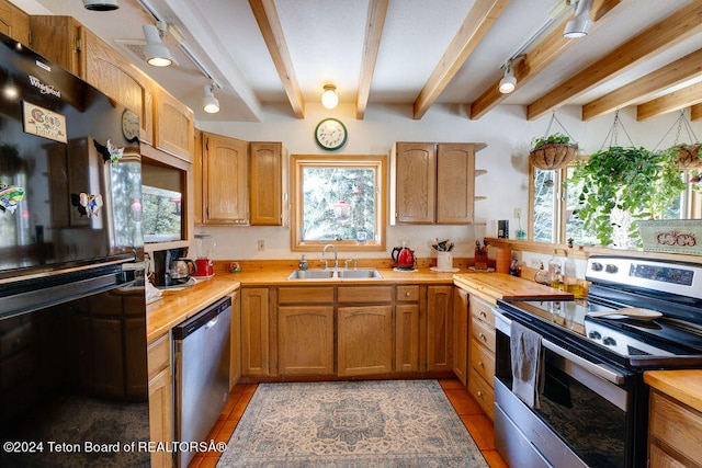 kitchen featuring beamed ceiling, sink, light tile flooring, and stainless steel appliances