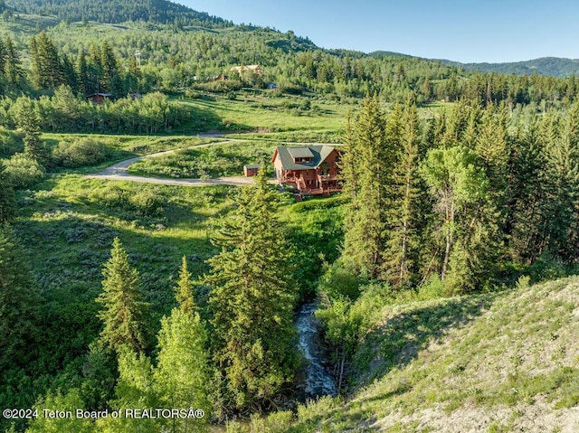 aerial view with a wooded view and a mountain view