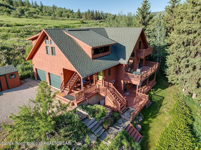 drone / aerial view featuring a wooded view