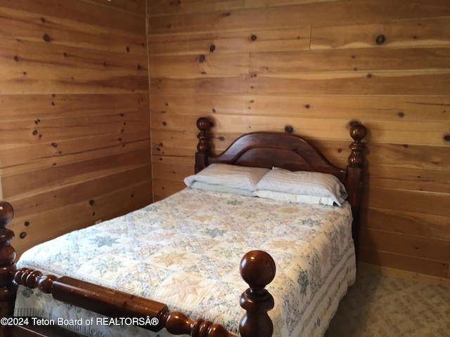 bedroom featuring wood walls