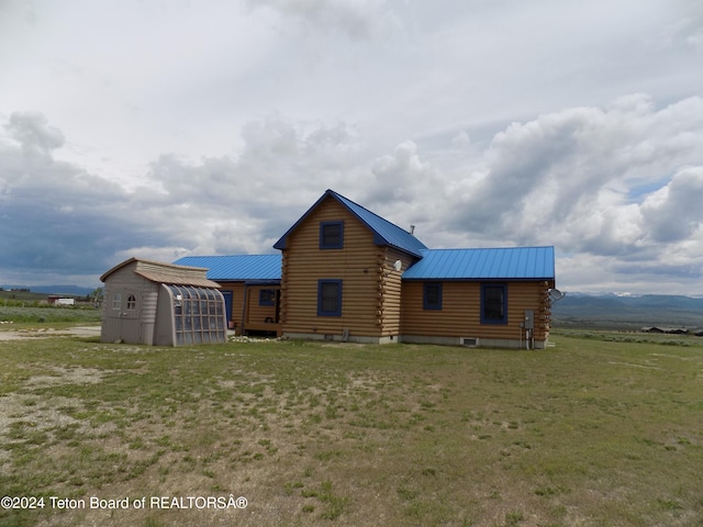 back of property featuring an outdoor structure