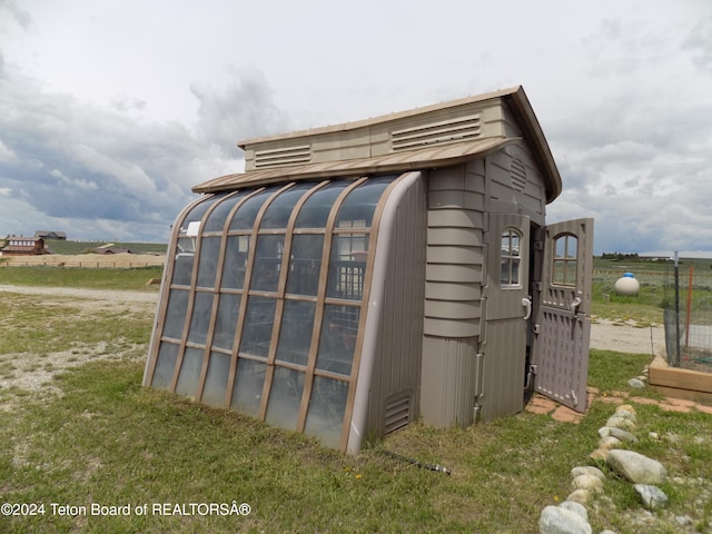 view of outbuilding with a yard