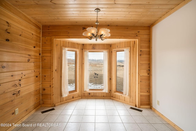 entryway with light tile patterned flooring, wood ceiling, wooden walls, and a chandelier