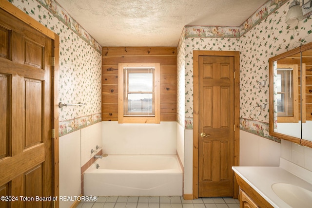 6 Black Bear Rd, Pinedale, WY 82941 - bathroom with wallpapered walls, a textured ceiling, vanity, a garden tub, and tile patterned floors