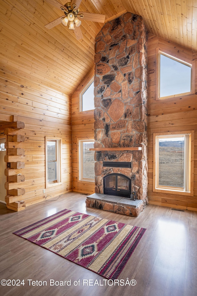 unfurnished living room with wooden ceiling, high vaulted ceiling, a healthy amount of sunlight, and hardwood / wood-style flooring