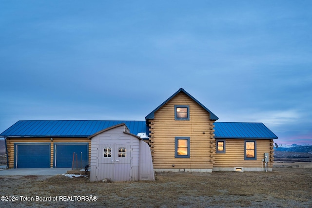 6 Black Bear Rd, Pinedale, WY 82941 - view of home's exterior with log siding, a metal roof, an attached garage, and driveway