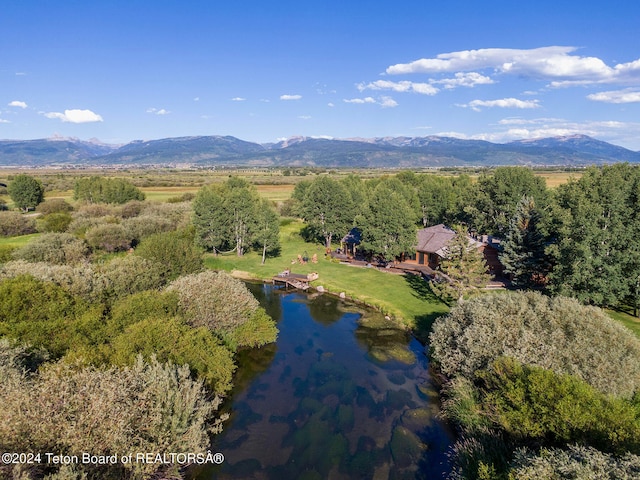 drone / aerial view featuring a water and mountain view