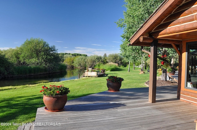 wooden deck featuring a yard and a water view