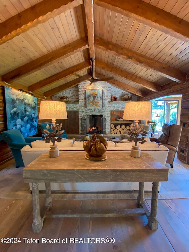 dining space featuring wood ceiling, dark hardwood / wood-style flooring, lofted ceiling with beams, and a stone fireplace