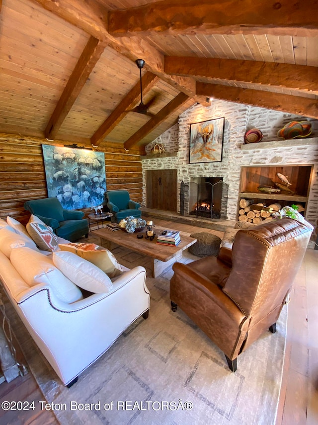 living room featuring lofted ceiling with beams, a fireplace, wooden ceiling, log walls, and hardwood / wood-style flooring