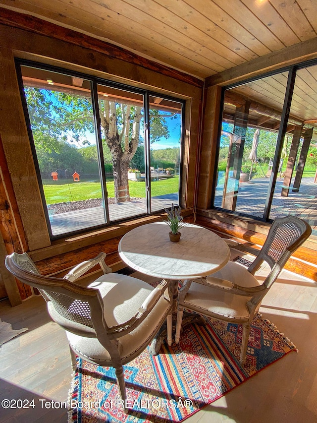 sunroom with wooden ceiling and a healthy amount of sunlight