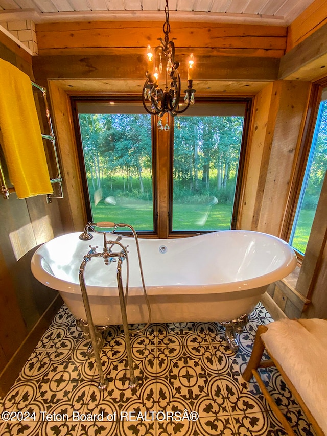 bathroom featuring wood ceiling, plenty of natural light, a bath to relax in, and tile floors