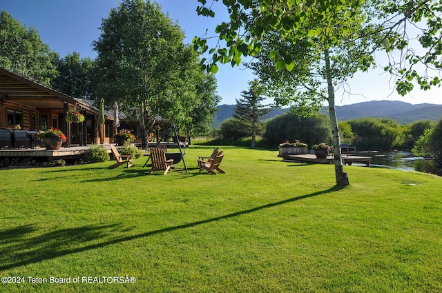 view of yard featuring a deck with water view