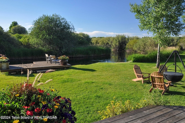 view of yard with a deck with water view