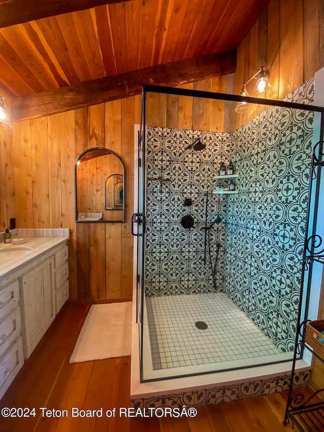 bathroom featuring wood-type flooring, vanity, wooden walls, and wooden ceiling