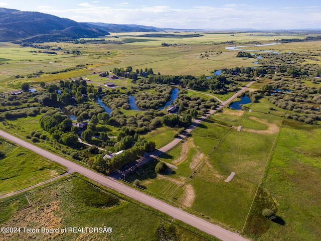 aerial view with a water and mountain view and a rural view