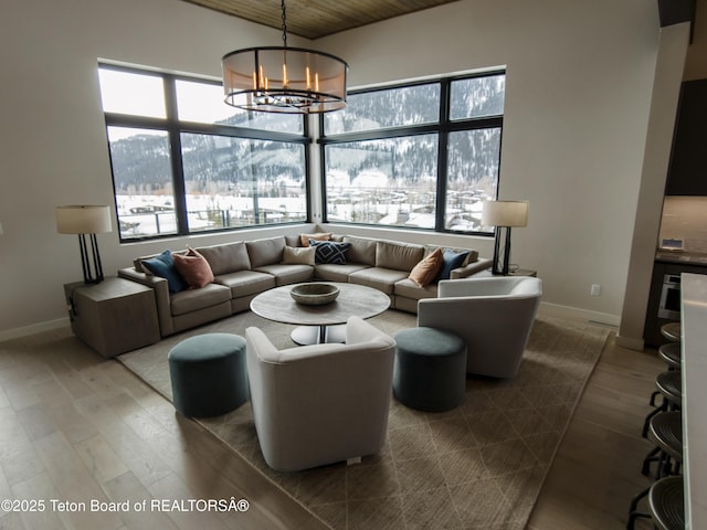 living room with hardwood / wood-style flooring, wooden ceiling, and a chandelier