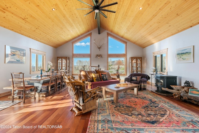 living room with light wood-type flooring, beamed ceiling, ceiling fan, and high vaulted ceiling