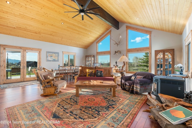 living room featuring high vaulted ceiling, hardwood / wood-style flooring, and a healthy amount of sunlight