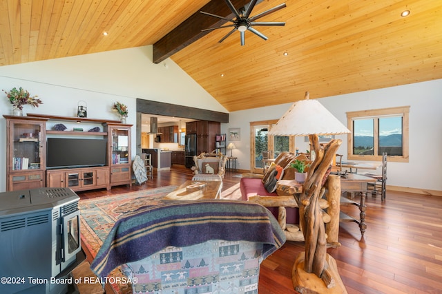 living room with ceiling fan, beam ceiling, wood-type flooring, and a wealth of natural light