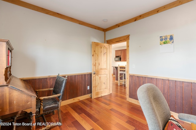 office area featuring wood walls and hardwood / wood-style floors